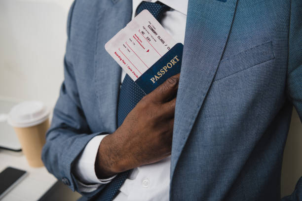 istock man hiding passport and ticket in suit 903394246