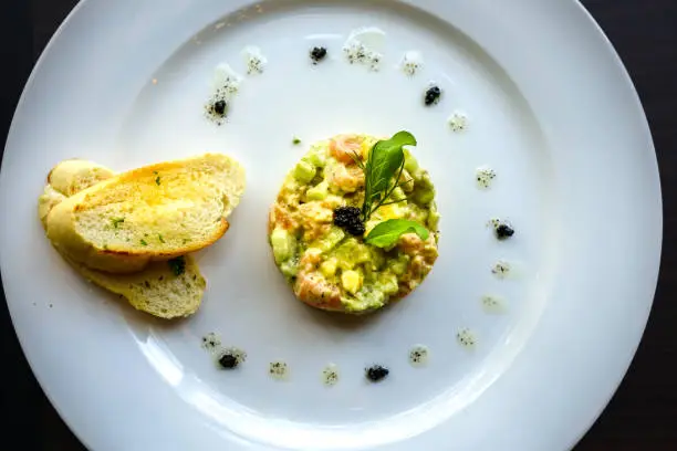 Tuna and avocado tartare serve with toasted French bread baguette