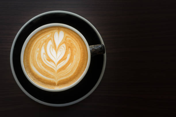 istock Latte are aromatic cappucino coffee serve in a black cup 903395052