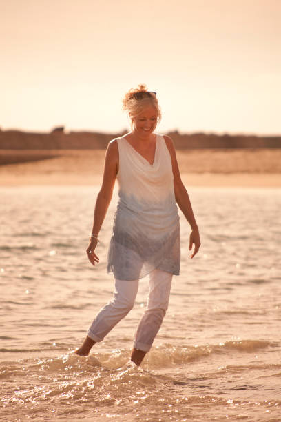 istock Happy woman on beach 3 903401512