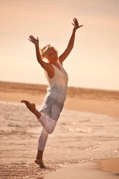 istock Happy woman on beach 5 903401606