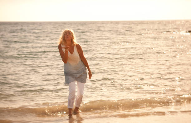 istock Happy woman on beach 8 903402068