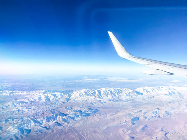 istock Mountains in the airplane window 903406042