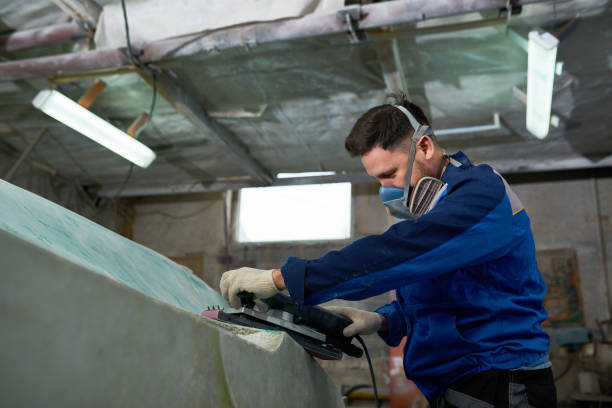 istock Man Polishing Yacht in Workshop 903410318