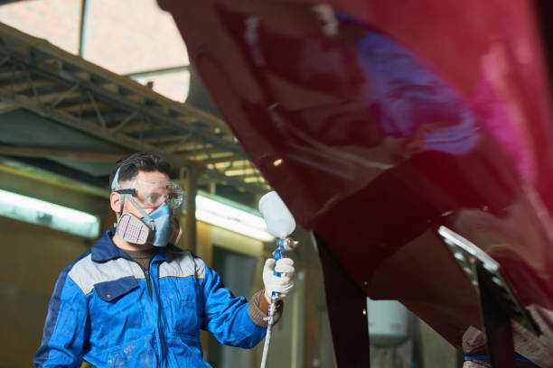 istock Modern Worker Painting Boat in Workshop 903412526