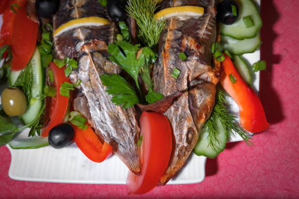 istock fish sterlet baked sturgeon with fresh vegetables 903412600