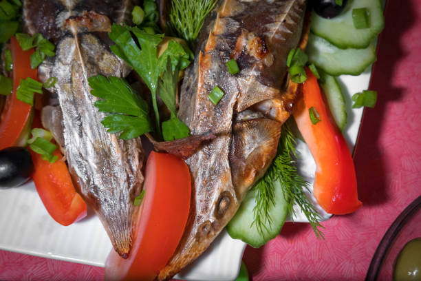 istock fish sterlet baked sturgeon with fresh vegetables 903412608