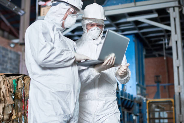 istock Workers in Hazmat Suits at Factory 903412642