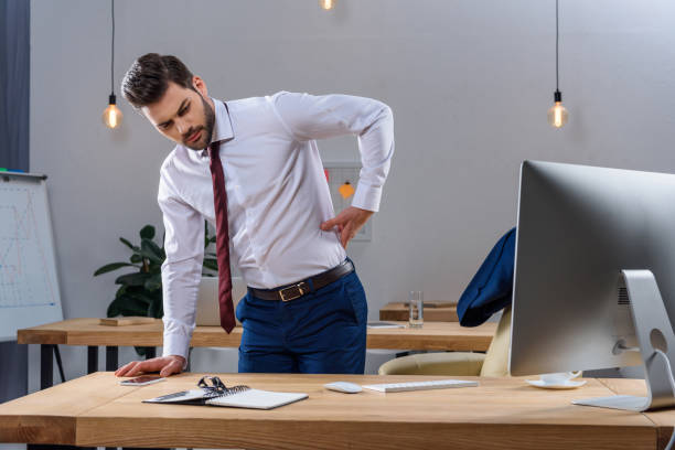 istock young businessman having pain in back 903413770