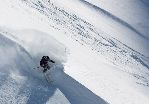 istock Man athlete running downhill on sunny alpine slope 903414060