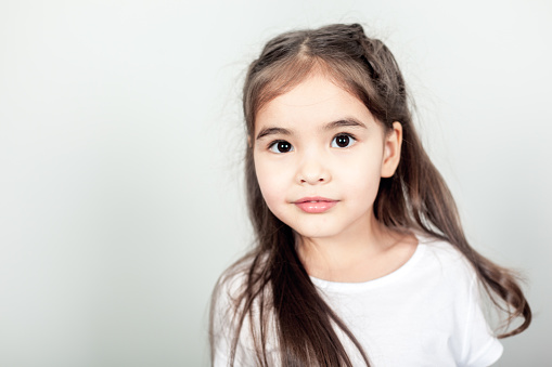 Eight-year-old brunette happy to be photographed in her favorite dress.