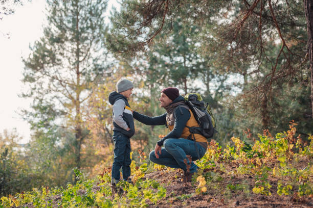 istock father and son hiking together 903416368