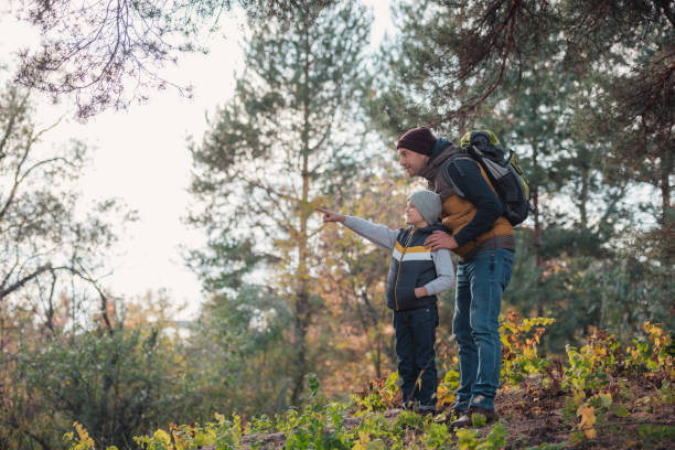 istock father and son hiking together 903416744