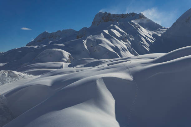 istock Low angle view of snow-capped mountains against clear blue sky 903417388