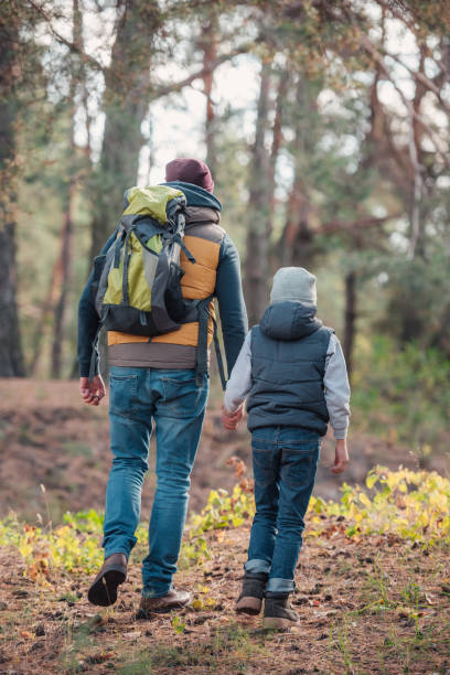 istock father and son hiking together 903417458