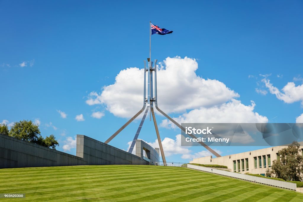 Spire with Australian Flag Australian Parliament Canberra Capital Hill Australian Flag on steel spire at the Australian 'New' Parliament House, the meeting place of the Parliament of Australia. Capital Hill, Canberra, Australian Capital Territory, Australia Parliament House - Canberra Stock Photo