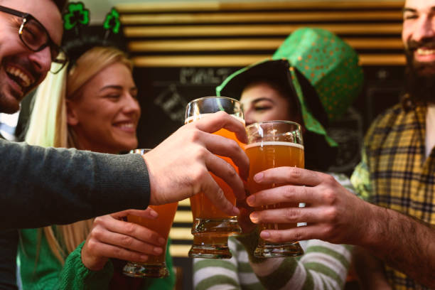 istock Group of Friends Celebrating St Patrick's Day at Beer Pub 903420404