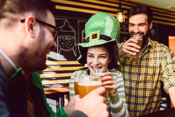 istock Group of Friends Celebrating St Patrick's Day at Beer Pub 903420466