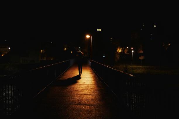 istock a man with an umbrella on the bridge 903424058