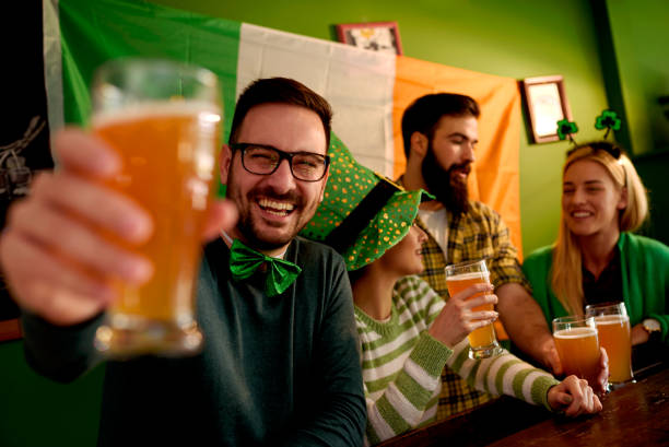 istock Group of Friends Celebrating St Patrick's Day at Beer Pub 903425108