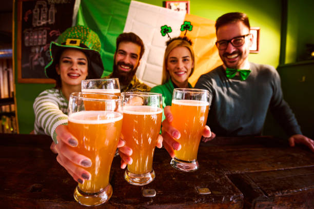 istock Group of Friends Celebrating St Patrick's Day at Beer Pub 903427818