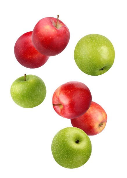 istock Falling red and green apples isolated on white. 903427902