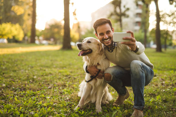 Selfie with my boy Handsome man making selfie with his dog. walking point of view stock pictures, royalty-free photos & images