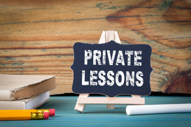 istock Private Lessons, education concept. small wooden board with chalk on the table 903454122
