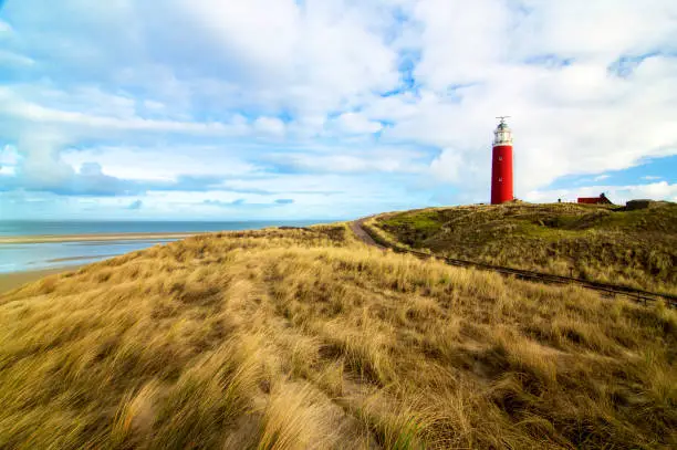 Lighthouse Texel on Blue Cloudy Sky background Outdoors. Nationalpark Duinen van Texel, Texel Island, Netherlands