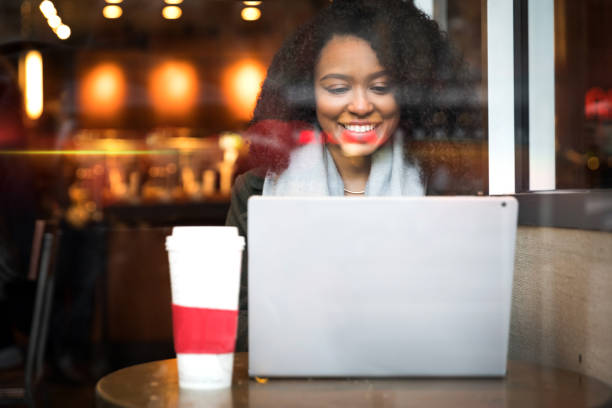 istock Young woman working on the move at cafe 903465484