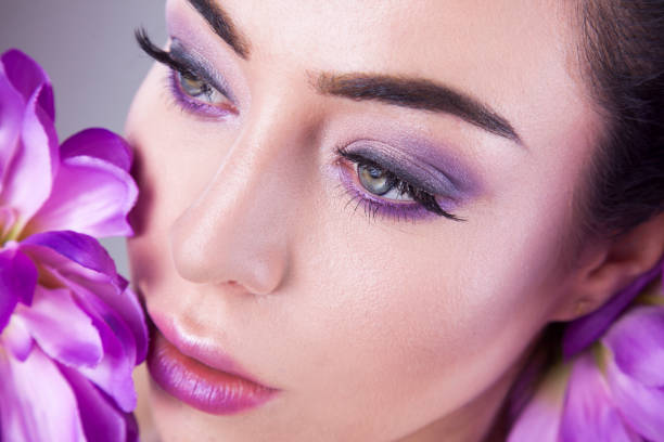 istock Make up trendy. Beauty shooting with purple flower. 903468692