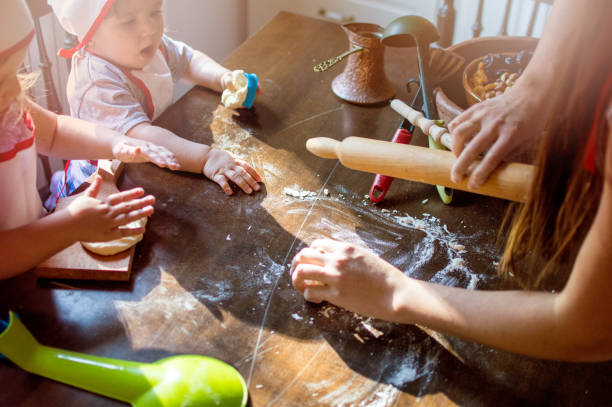 istock Mother Teaching to bake pastry her daughters 903477158