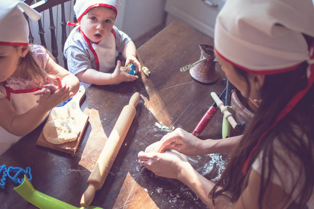 istock Mother Teaching to bake pastry her daughters 903477336