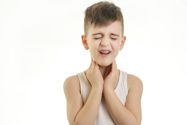 Studio shot of young boy with sore throat stock photo