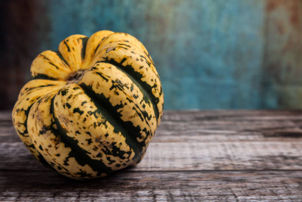 istock Green and Yellow Sweet Dumpling Squash on wooden table with copy space 903486164