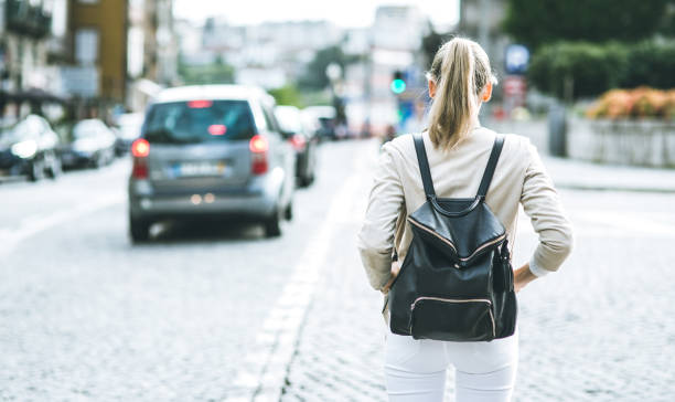 istock Young woman with backpack walking on the european streets 903490486