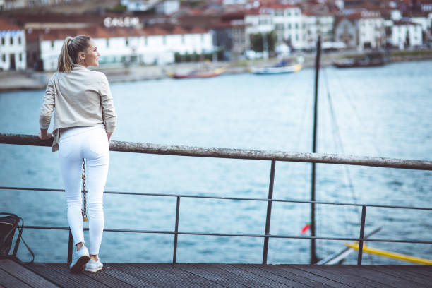 istock Young woman is watching to the river 903490740