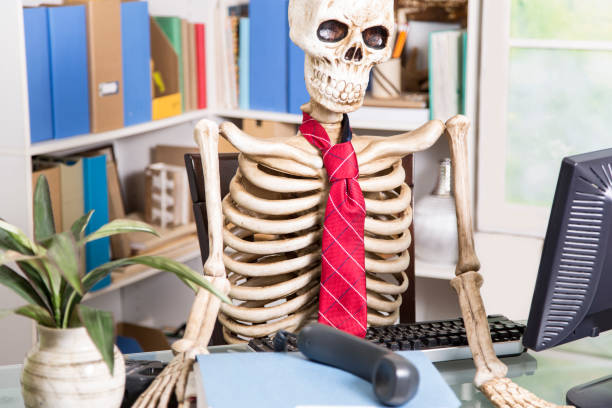istock Skeleton businessman worked to death in office. 903490936