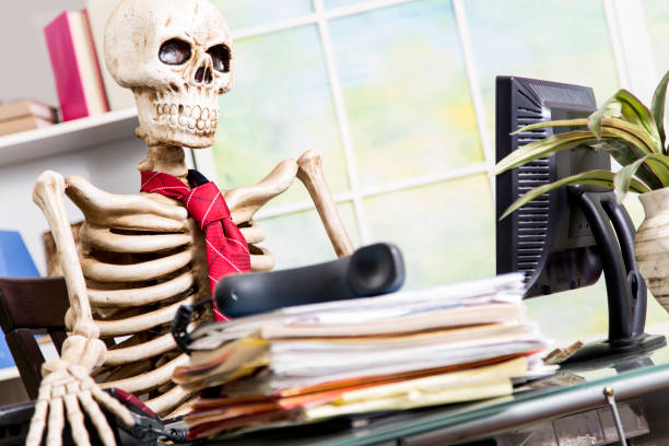 istock Skeleton businessman worked to death in office. 903490956