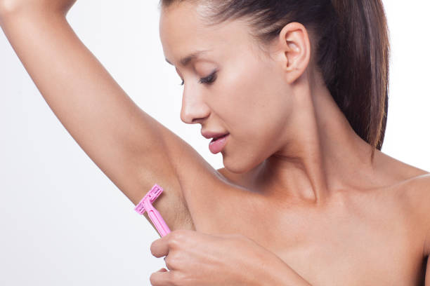 istock Body care. Young woman shaving her armpit. 903491774