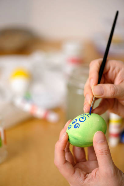 istock Close up of hands coloring easter egg 903494422