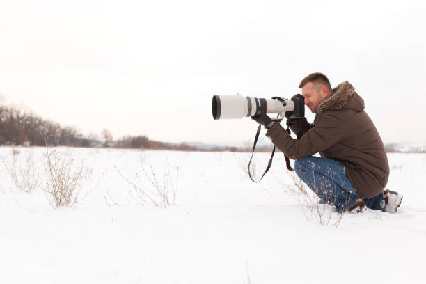 istock Man taking pictures in winter 903495024