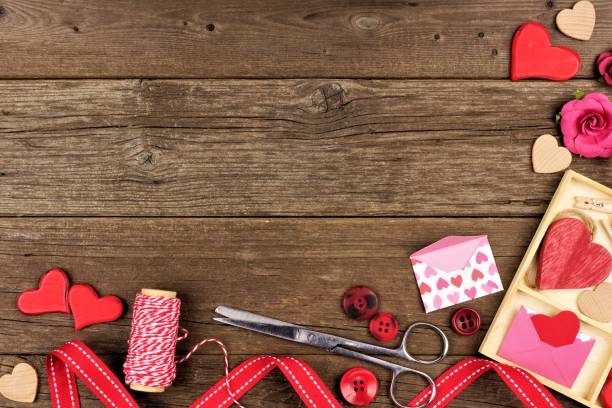 istock Valentines Day craft concept corner border against rustic wood 903502404