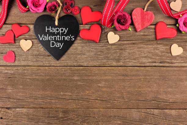 istock Happy Valentines Day heart shaped chalkboard tag with border against rustic wood 903502408