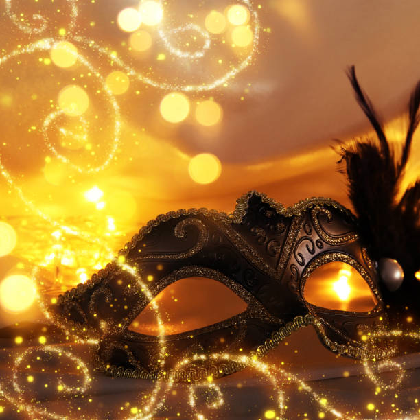 istock Image of elegant venetian mask over gold silk background. 903505646