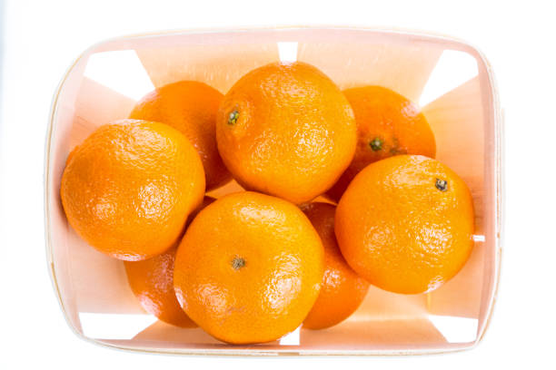 istock Orange tangerines mandarin in a box isolated on white background. Top view. Close up image 903505832