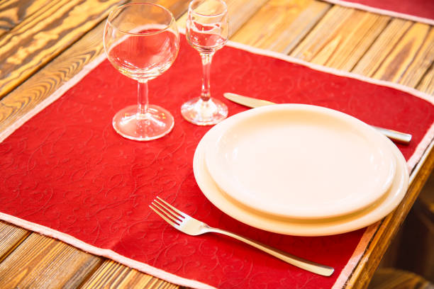 istock Empty glasses set with plate and knife on a wooden table in restaurant 903505848