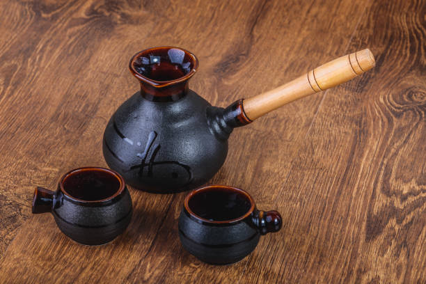 istock clay turka and cups for coffee on a wooden background 903506620