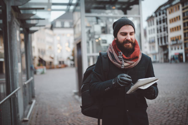 istock Young man using digital tablet in the city street 903510072