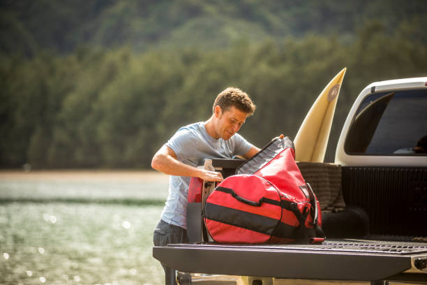 Young man on surfing road trip in Hawaii. stock photo